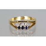 AN 18CT GOLD, DIAMOND AND SAPPHIRE RING.