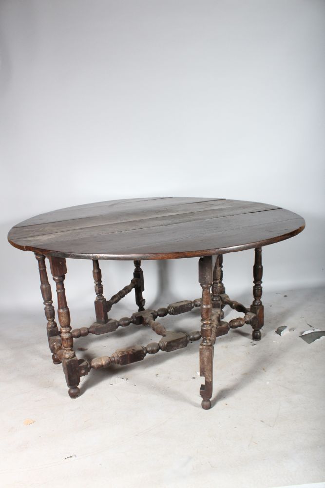 AN 18TH CENTURY OAK OVAL DROP FLAP GATE-LEG DINING TABLE. 4ft 10ins wide x 4ft 5ins deep. - Image 2 of 2