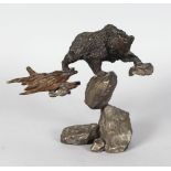 A GOOD BRONZE OF A BEAR standing on rocks. Signed. No. 202 of 750. 7ins high.