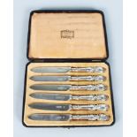 A SET OF SIX VICTORIAN FRUIT KNIVES, in a fitted Harrod's case. London 1898. Maker: Huttons.