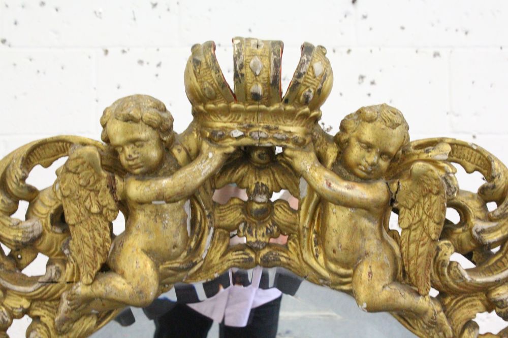 A GOOD 18TH CENTURY ITALIAN CARVED AND GILDED MIRROR, the frame carved with four winged cupids, - Image 2 of 2