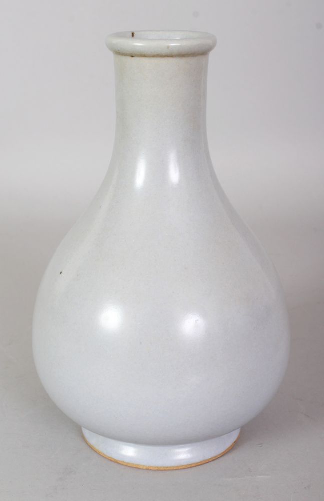 A CHINESE JUN STYLE PORCELAIN BOTTLE VASE, applied with a pale blue-green glaze, 8in high.