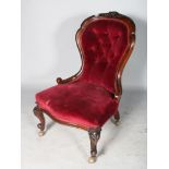 A VICTORIAN MAHOGANY BUTTONED BACK NURSING CHAIR, with open wood frame on cabriole legs.