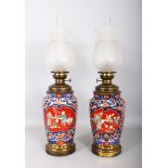 A PAIR OF IMARI VASES with cartouches and floral motifs, now converted as lamps. 1ft 5ins each (2).