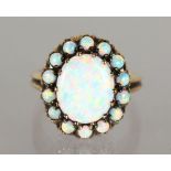 A 9CT GOLD OVAL OPAL DRESS RING.