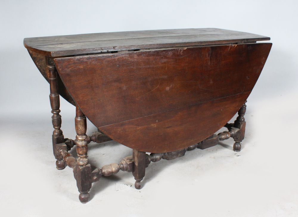 AN 18TH CENTURY OAK OVAL DROP FLAP GATE-LEG DINING TABLE. 4ft 10ins wide x 4ft 5ins deep.