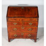 A GEORGE II WALNUT BUREAU, with herringbone inlay, the fitted front opening to reveal a fitted