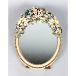 A LEATHER FLORAL OVAL EASEL MIRROR. 17ins long.