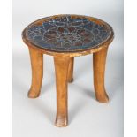 AN EARLY 20TH CENTURY FOUR LEGGED KAMBA KENYAN STOOL, decorated top in red and blue beads. 13ins