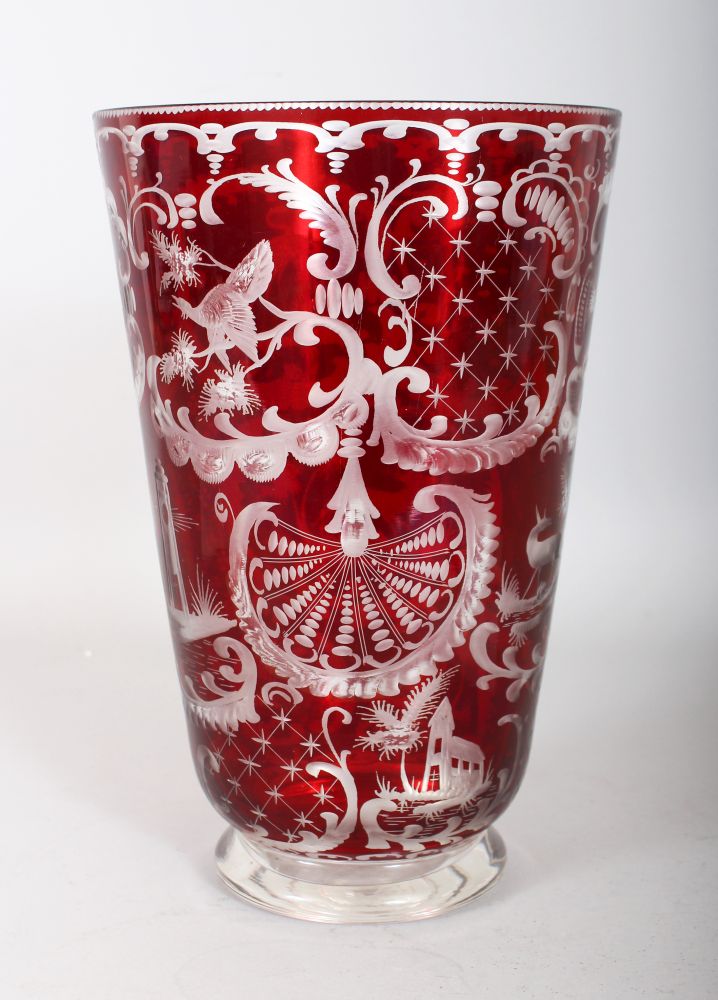 A BOHEMIAN RED GLASS VASE, with engraved decoration. 10ins high.