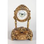 A SUPERB SILVER GILT MUSICAL CLOCK, with painted dial, the case with scrolls and leaves and set with