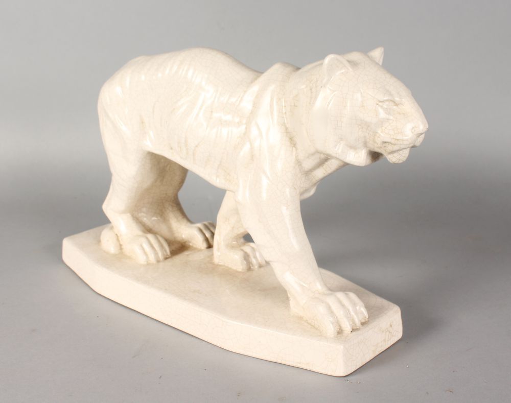 AN ART DECO STYLE POTTERY TIGER. 15ins long.