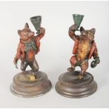 A PAIR OF METAL FOX CANDLESTICKS. 7ins high.