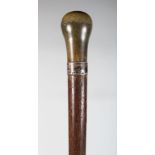 ANOTHER RHINO HORN HANDLED WOOD CANE, with a plain hallmarked silver collar, the shaped rhinoceros