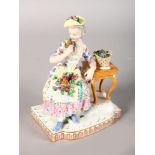 A 19TH CENTURY MEISSEN GROUP OF THE SENSES, a lady sitting beside a table with roses. Cross swords