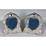 A PAIR OF SHAPED EASEL PHOTOGRAPH FRAMES, with heart shaped centres and winged cupids. London