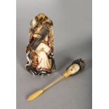 A CHINESE CARVED IVORY SNUFF BOTTLE, a seated woman with a musical instrument, with detachable head.