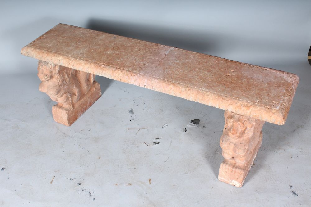 A CARVED RED STONE SEAT with lion supports. 4ft 4ins long. - Image 2 of 2