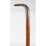 A WALKING STICK WITH RHINO HANDLE.