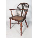 A YEW WOOD AND ELM WINDSOR ARMCHAIR with cow horn stretcher.