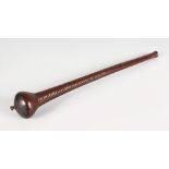 A CARVED WOOD THROWING CLUB. 19ins long.