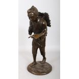 A JAPANESE BRONZE FIGURE OF A BOY GATHERING WOOD. 1ft 4ins high.