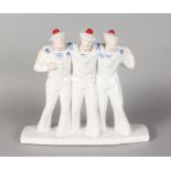 AN ART DECO STYLE POTTERY GROUP OF THREE SAILOR BOYS. 11ins high.