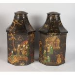 A PAIR OF BLACK PAINTED TOLEWARE OCTAGONAL TEA CANISTERS AND COVERS. 15ins high.