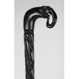 A CEYLONESE SILVER MOUNTED EBONY WALKING STICK.