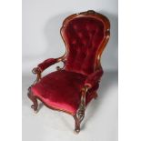 A GOOD VICTORIAN BUTTON BACK ARMCHAIR with red velvet cover, supported on cabriole legs.