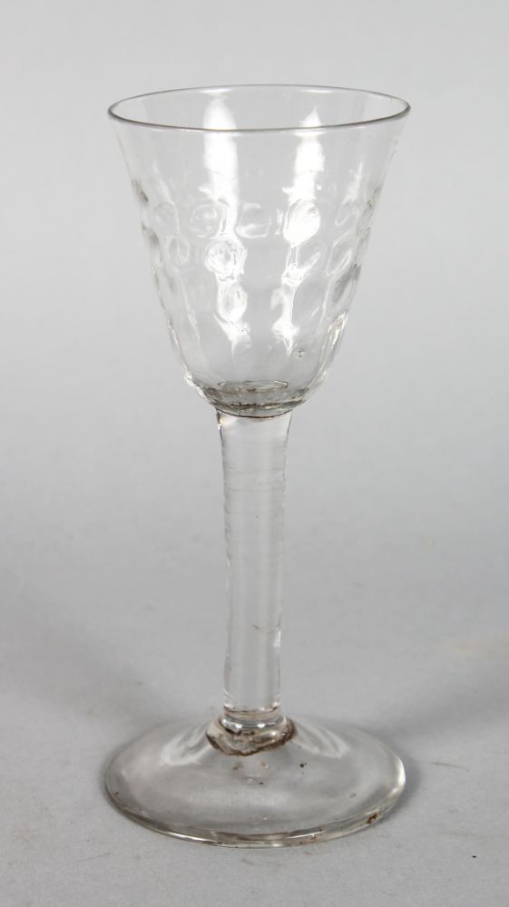 AN EARLY ENGLISH WINE GLASS with dimple bowl. 6.25ins high.