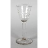 AN EARLY ENGLISH WINE GLASS with dimple bowl. 6.25ins high.