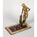 A COLD CAST PAINTED BRONZE NUDE WITH A TIGER on a Persian rug. 7ins high.