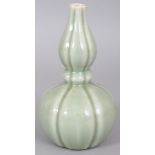 A CHINESE CELADON DOUBLE GOURD PORCELAIN VASE, of fluted hexafoil section, the base with a