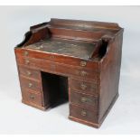 A GEORGIAN MAHOGANY RENT DESK , the top with rising writing surface, one long drawer, two drawers to