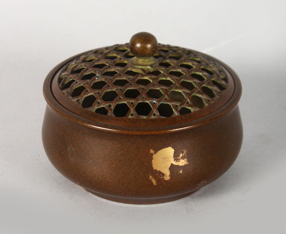 A CHINESE BRONZE GOLD SPLASH CENSER AND COVER, stamped to the base. 3ins diameter.