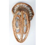 AN EARLY 20TH CENTURY PAPUA NEW GUINEA WOVEN YAM MASK.