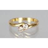 AN 18CT GOLD AND DIAMOND CROSSOVER RING.