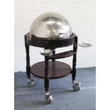 A RECTANGULAR CIRCULAR SERVING TROLLEY with swivel lid, on turned legs with under-tier. 3ft high x