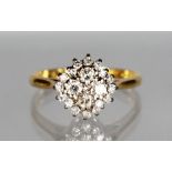 AN 18CT GOLD DIAMOND CLUSTER RING.