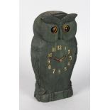 AN AUTOMATED WOODEN OWL CLOCK with moveable eyes. 9ins high.