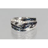 A 14CT WHITE GOLD, BLUE AND WHITE SAPPHIRE CROSSOVER RING.