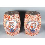 A PAIR OF OCTAGONAL IMARI POTTERY GARDEN SEATS decorated with foliate motifs. 18ins high.