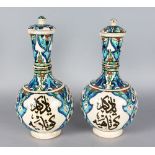 A PAIR OF ISLAMIC BOTTLE VASES AND COVERS with calligraphy. 13ins high.