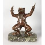 AN AMUSING BRONZE FROG CONDUCTOR holding two batons, standing on a marble base. 12ins high.