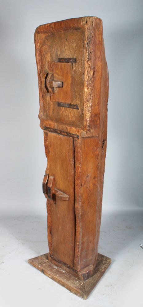 CARVED OUT OF THE SOLID. AN UNUSUAL TALL STANDING CUPBOARD, with two panel doors. 6ft high x 1ft