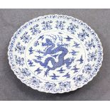A VERY LARGE MING STYLE BLUE AND WHITE CIRCULAR DISH, the centre with a dragon. 46ins diameter.