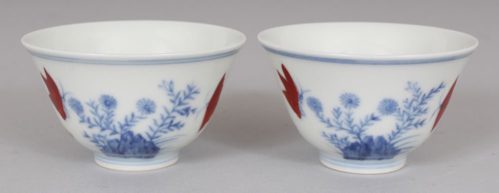 A PAIR OF MING STYLE DOUCAI PORCELAIN CUPS, decorated with butterflies, ferns and rockwork, each - Image 3 of 7