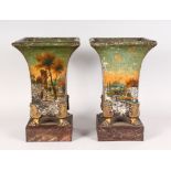 A GOOD PAIR OF TOLE PERIOD SQUARE SHAPED VASES, painted with a village scene, supported on four claw