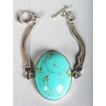 A SILVER TURQUOISE PENDANT.